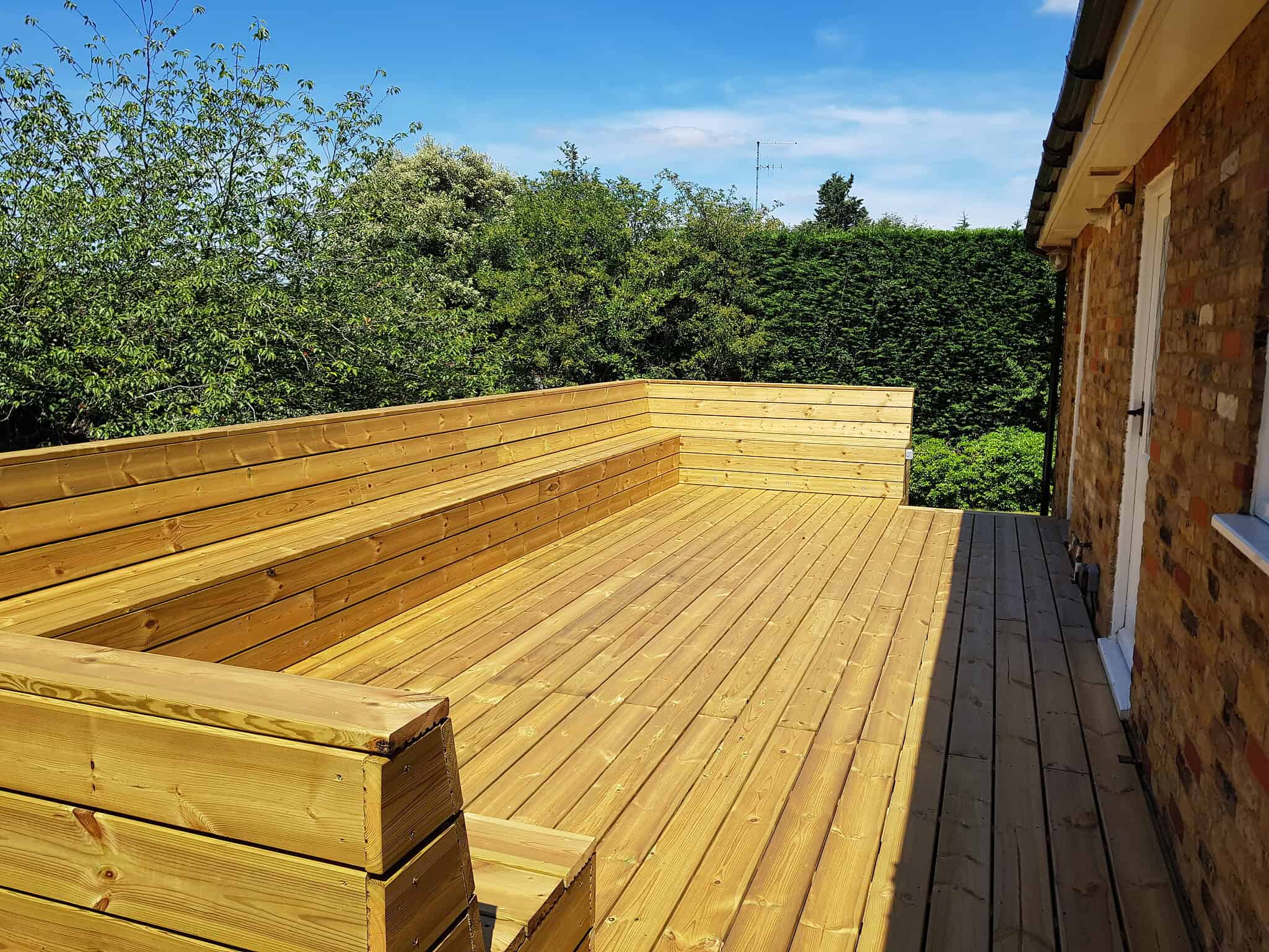 Large softwood decking area in London for outdoor living and entertainment.