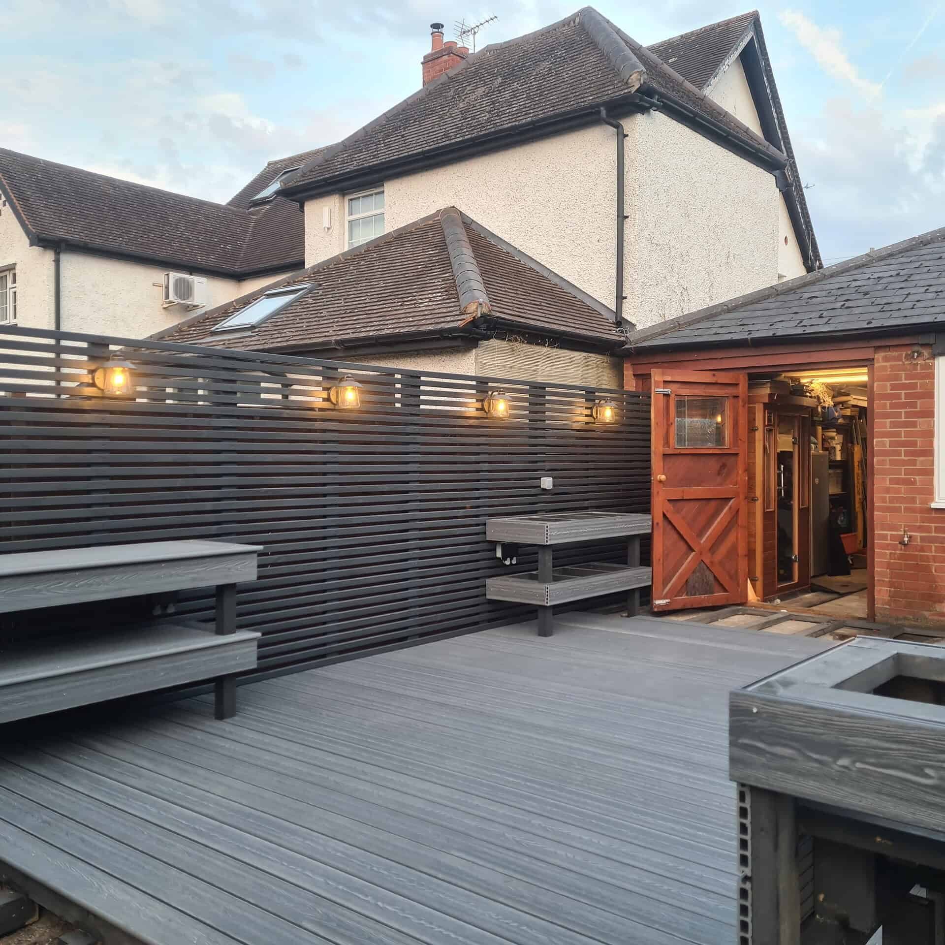 Composite decking in Reading with stylish outdoor seating and privacy fencing.