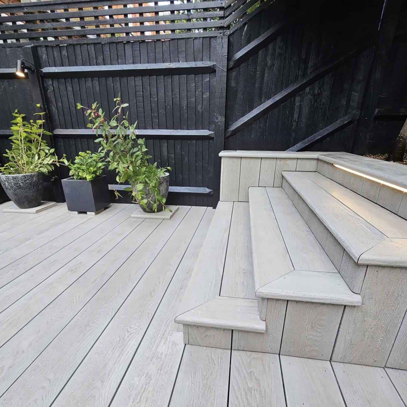 Beautiful composite decking with steps in Windsor garden. Durable, low-maintenance material enhances.